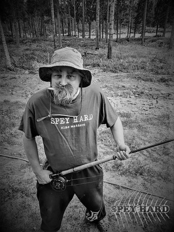 Man wearing Spey Hard size matters t-shirt with spey rod